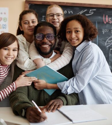 group-of-kids-hugging-their-teacher